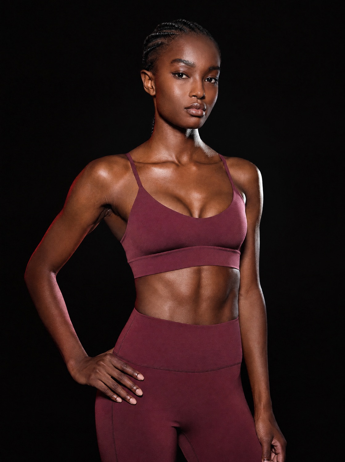 Athlete in an oxblood seamless sculpt set against black